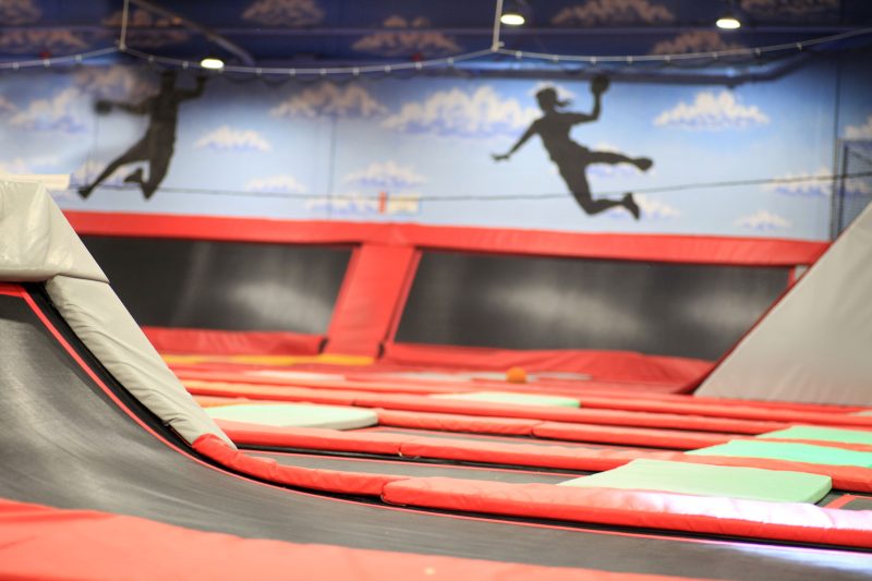 Children jumping at an indoor trampoline park where collisions, falls, and unsafe conditions can lead to serious trampoline park injuries