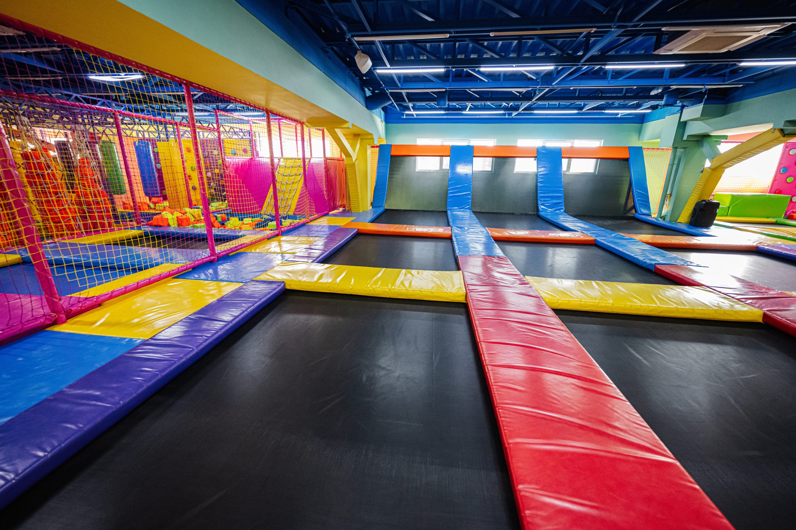 Indoor trampoline park with multiple jumping areas where serious trampoline injuries can occur due to unsafe conditions or inadequate supervision